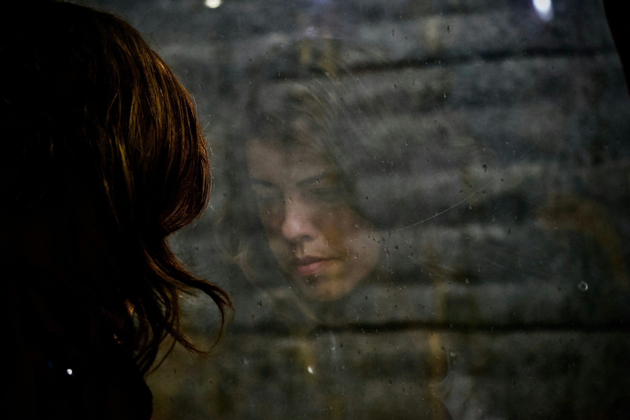 sad woman looking at her reflection | Hidden River residential eating disorder treatment center