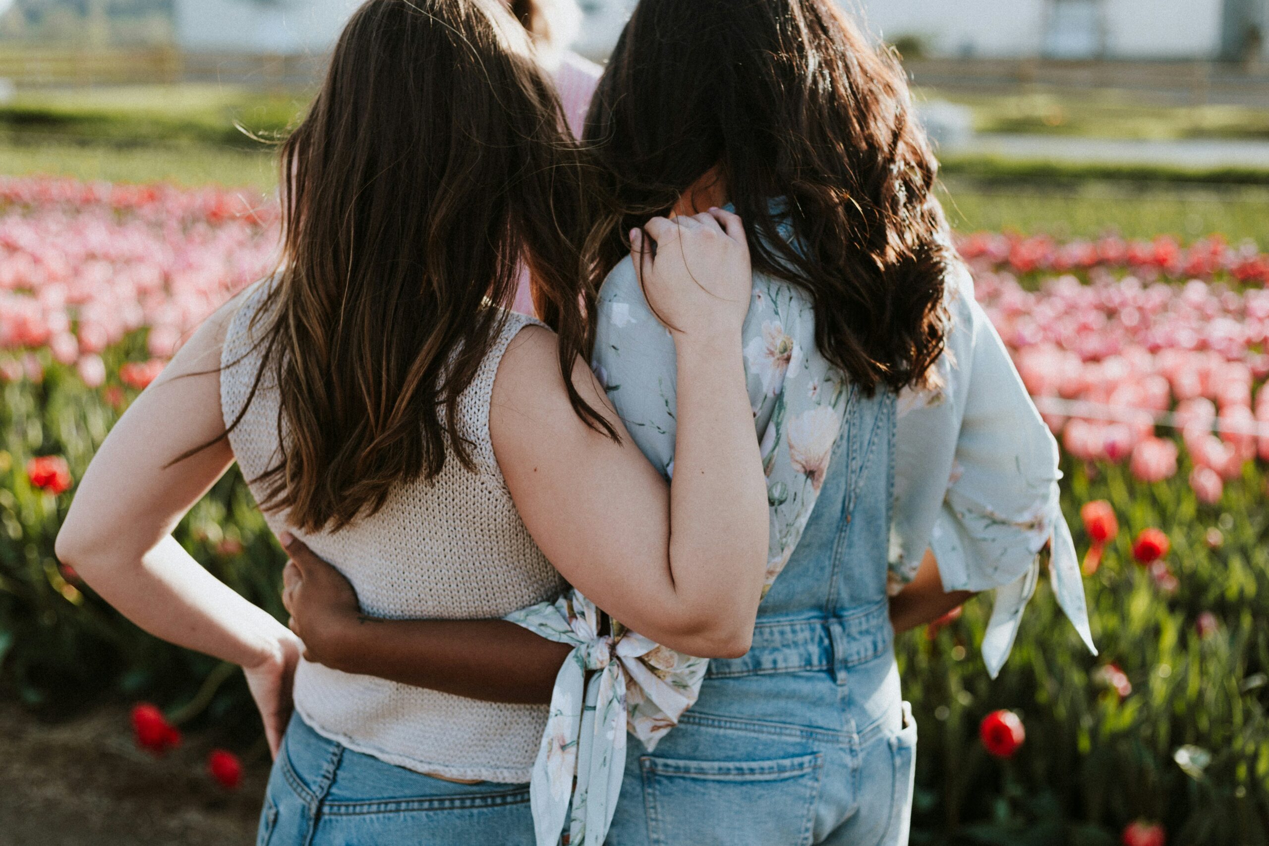 two girls hugging from behind | hiddenriverhealing.com body image