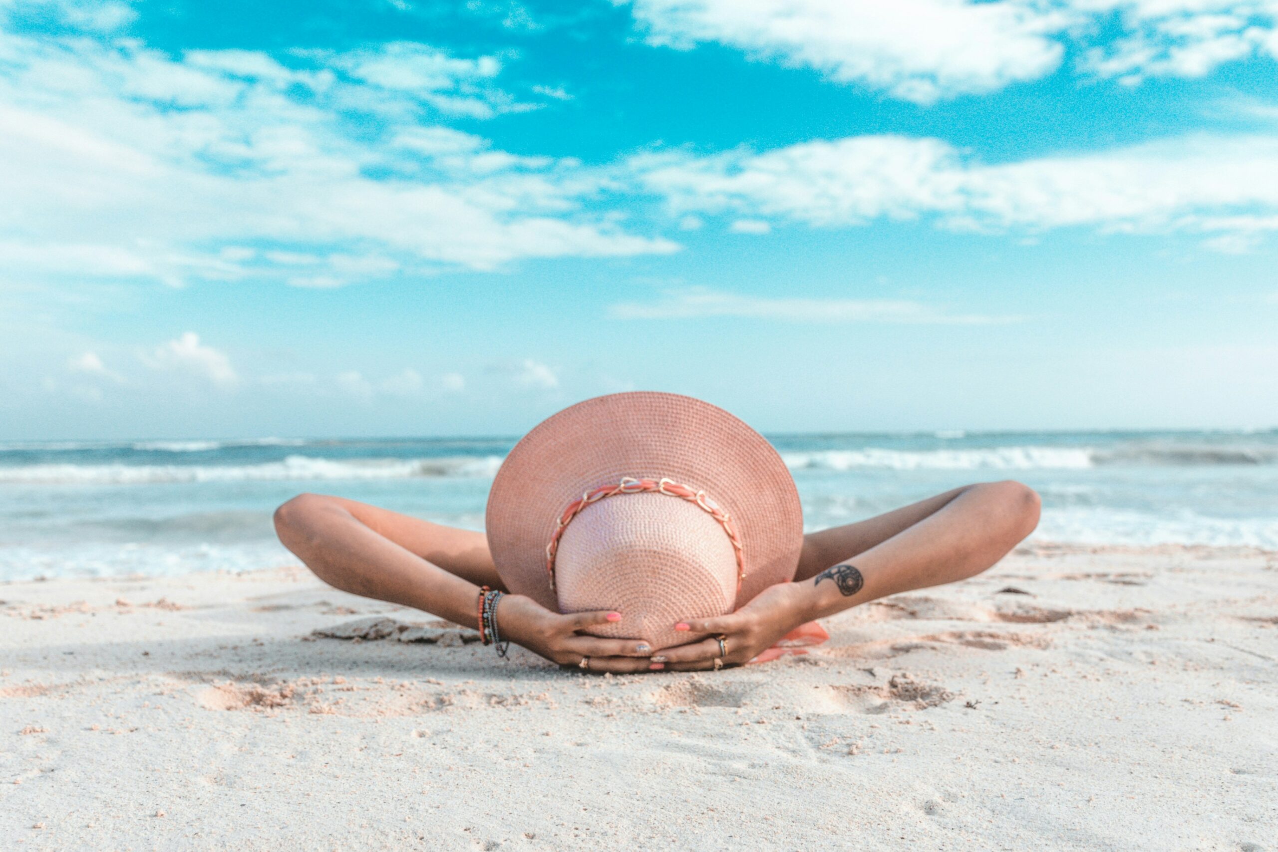 woman laying on the beach | hiddenriverhealing.com